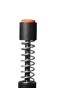 Spring return mechanism in an industrial shock absorber